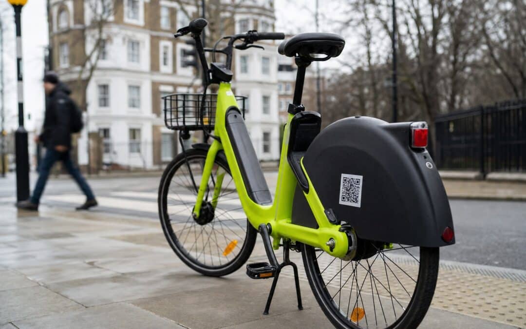 Lime e-bike parked on a London pavement near a pedestrian crossing